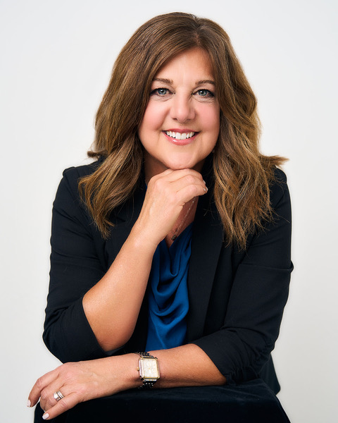 Studio portrait of Maria Sainz smiling, soft editorial lighting, shoulder-up frame suitable for interviews and features.